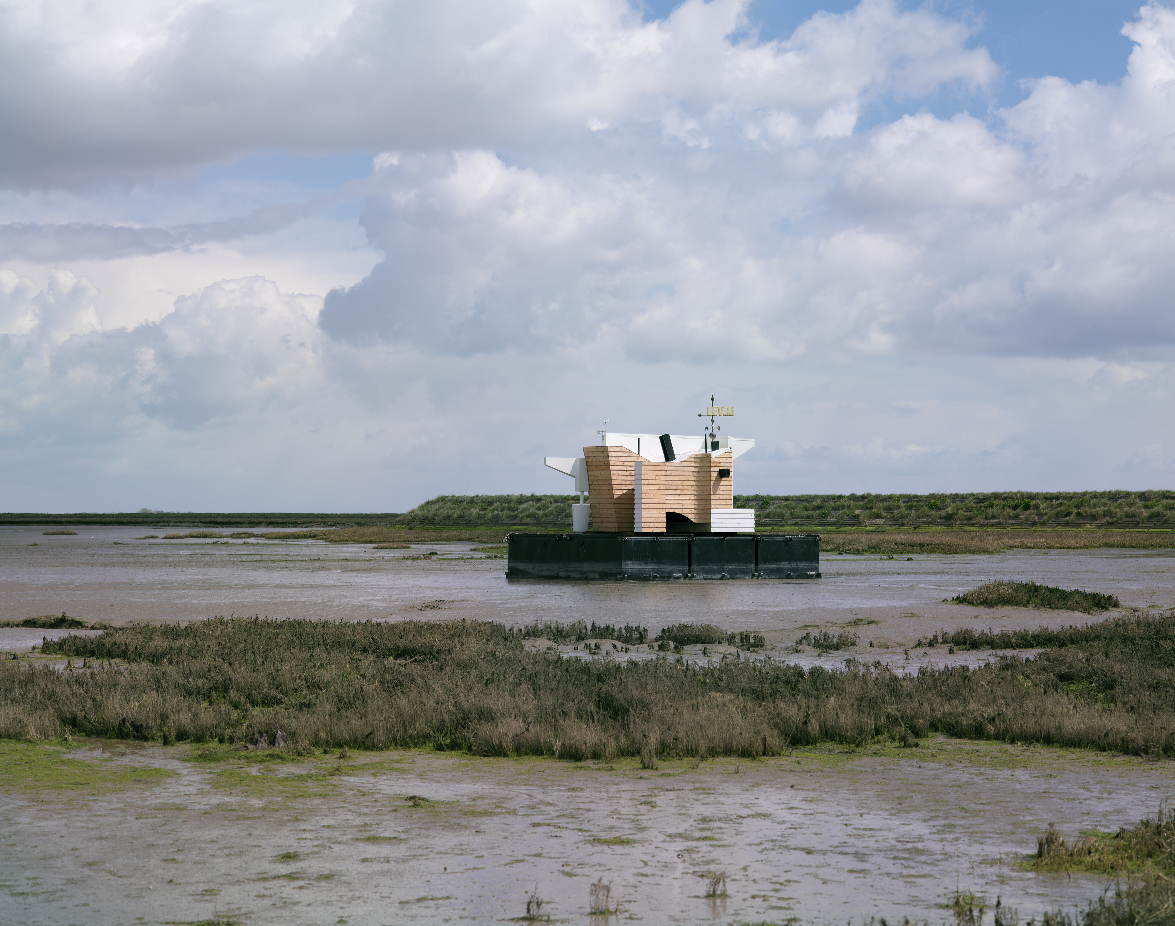 Photo of Flood House on the Thames Estuary, partly cloudy skies